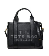 "MARC JACOBS The Small Tote Bag, featuring a compact design with sturdy handles and the signature logo. Made from high-quality materials, this stylish tote is perfect for daily use, offering both practicality and chic appeal."