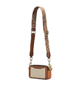 "MARC JACOBS The Snapshot Crossbody Bag, featuring a compact design with a sleek silhouette. The bag includes an adjustable strap and a bold logo, making it a stylish and functional accessory for everyday use."
