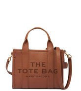 "Marc Jacobs Argan Oil The Tote Small Satchel for women, featuring a warm argan oil color and a compact design. The satchel includes sturdy top handles and a spacious interior, combining style and practicality for everyday use.