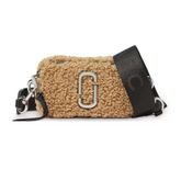 Marc Jacobs Beige Snapshot Teddy Small Crossbody Bag for women, featuring a soft teddy texture and a chic beige color. The bag includes a removable strap and a compact design, combining style and practicality for everyday use."