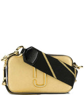 Marc Jacobs Golden Snapshot Small Crossbody Bag for women, featuring a shimmering gold finish and a compact design. The bag includes an adjustable strap and the iconic logo, making it a stylish and glamorous accessory for any occasion."