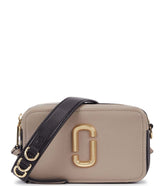 "Marc Jacobs Grey The Softshot 21 Small Crossbody Bag, featuring a sleek grey design with a compact silhouette. The bag includes an adjustable strap and the signature logo, making it a stylish and functional accessory for everyday use."
