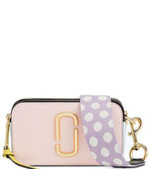 "Marc Jacobs Light Pink Snapshot Small Crossbody Bag for women, featuring a soft light pink hue and a compact design. The bag includes an adjustable strap and the signature logo, making it a stylish and versatile accessory for everyday use.