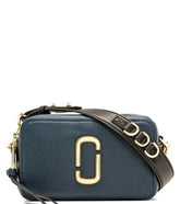 Marc Jacobs Navy Blue The Softshot 21 Small Crossbody Bag for women, featuring a deep navy color and a sleek design. The bag includes an adjustable strap and a compact silhouette, making it a stylish and functional accessory for daily outings."