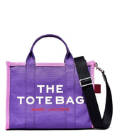 Marc Jacobs Purple Potion Multi The Tote Medium Satchel for women, featuring a vibrant purple color with contrasting accents. The satchel includes a spacious interior, sturdy handles, and a chic design, making it a stylish and functional choice for everyday use."