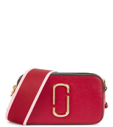 "Marc Jacobs Red Snapshot Small Crossbody Bag for women, featuring a vibrant red color and a compact design. The bag includes an adjustable strap and the signature logo, making it a stylish and eye-catching accessory for everyday use.