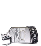 "Marc Jacobs Silver Striped Snapshot Small Crossbody Bag, featuring a sleek design with metallic silver stripes. The bag includes an adjustable strap and the signature logo, making it a stylish and eye-catching accessory for everyday use.