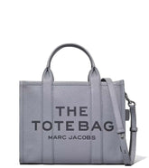 "Marc Jacobs Wolf Grey The Tote Medium Satchel for women, featuring a soft wolf grey color and a spacious design. The satchel includes sturdy top handles and a versatile interior, making it a stylish and practical accessory for everyday use."