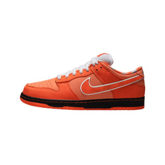 Nike SB Dunk Low "Concepts Orange Lobster" sneakers featuring a vibrant orange suede upper with contrasting red and white accents. The classic low-top design includes unique lobster-themed detailing and a white midsole, displayed in their regular box against a neutral background to highlight the shoe's playful and distinctive style.