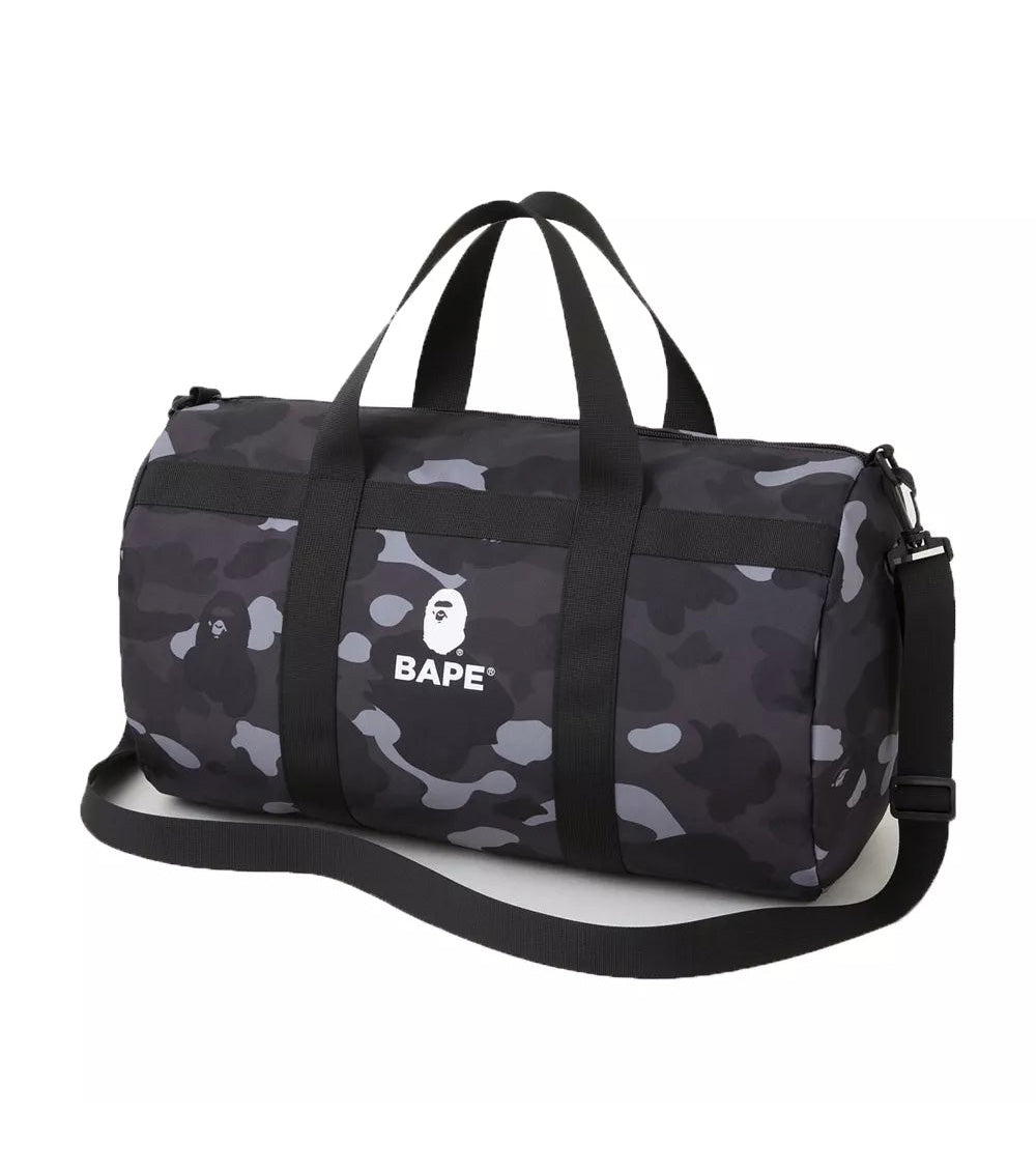 "Bape Black Camo Duffle Bag, featuring a bold black camouflage print and a spacious interior. The bag includes dual handles and an adjustable shoulder strap, making it a stylish and practical choice for travel or gym use."