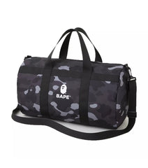 "Bape Black Camo Duffle Bag, featuring a bold black camouflage print and a spacious interior. The bag includes dual handles and an adjustable shoulder strap, making it a stylish and practical choice for travel or gym use."