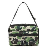 "Bape Green Camo Shoulder Bag, featuring a signature camouflage pattern in green tones. The bag includes an adjustable strap and a spacious interior, making it a stylish and functional accessory for casual outings."