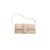 Jacquemus Le Bambino Flap Bag in off-white, showcasing a modern, structured design with a flap closure and a top handle. The handbag is crafted from smooth leather, exuding elegance and versatility, ideal for a chic women's accessory."