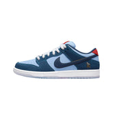 "Nike SB Dunk Low Pro 'Why So Sad?' sneakers, featuring a soft blue suede upper with contrasting dark blue accents and a playful sad face logo on the heel. The design includes a white midsole and a gum outsole, reflecting a whimsical yet emotional theme."
