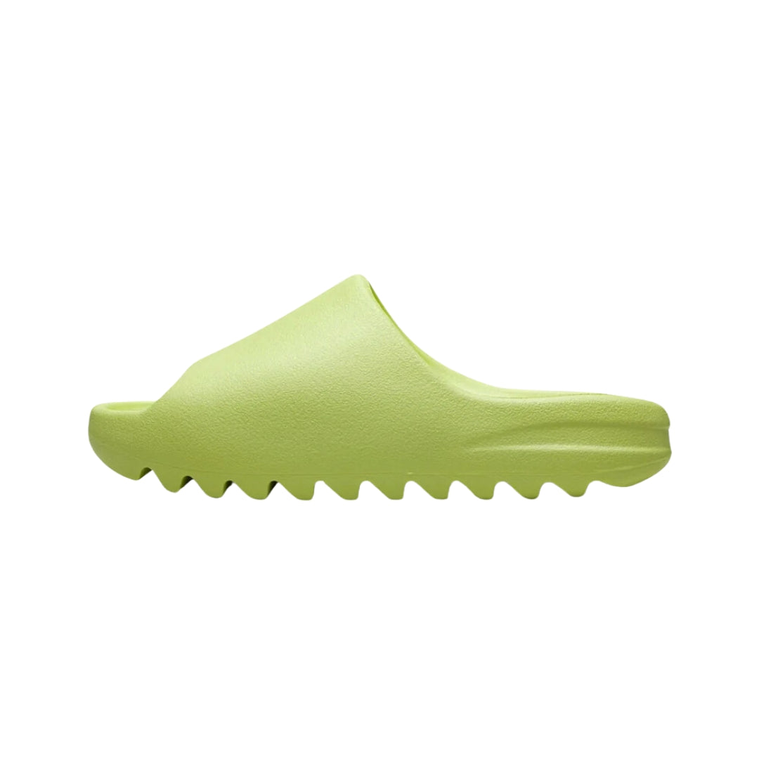 Adidas Yeezy Slide in the Glow Green colorway, featuring a sleek, slip-on design with a vibrant green upper and a contoured footbed, offering both style and comfort for casual wear."