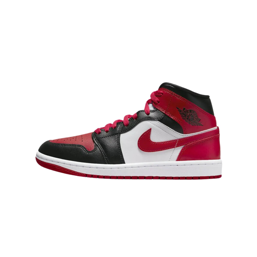 "Nike Air Jordan 1 Mid Alternate Bred Toe women's sneakers, showcasing a black leather upper with a vibrant red toe box and white midsole. The design features the iconic Air Jordan logo on the side, blending style and sport."