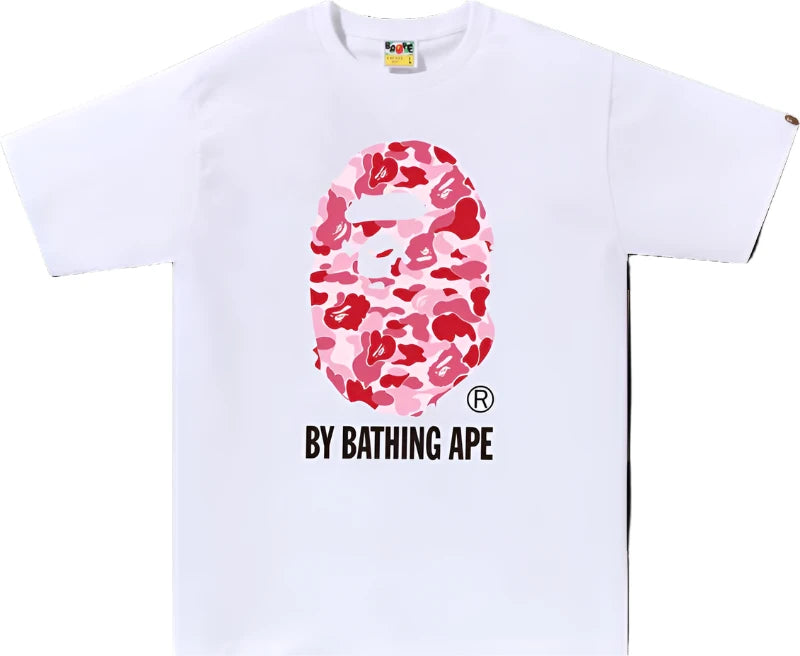 BAPE ABC Camo By Bathing Ape Tee White/Pink "White T-shirt featuring a pink ABC camo pattern along with the iconic BAPE logo, merging playful design with a trendy streetwear aesthetic."



