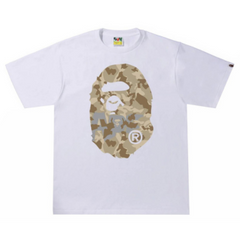 BAPE Sand Camo Big Ape Head Tee White/Beige "White and beige T-shirt featuring a sand camo pattern with a large ape head graphic, blending a unique design with a stylish streetwear look from BAPE."



