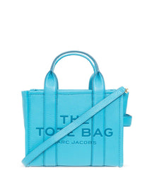 "Marc Jacobs Barrier Reef The Tote Small Satchel for women, featuring a vibrant blue color reminiscent of ocean hues. The satchel includes top handles and a spacious interior, combining a chic design with functionality for everyday use."



