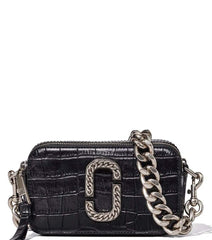 Marc Jacobs Black Snapshot Mini Crossbody Bag for women, featuring a classic black color and a compact design. The bag includes an adjustable strap and the iconic logo, offering a stylish and versatile accessory for daily use.



