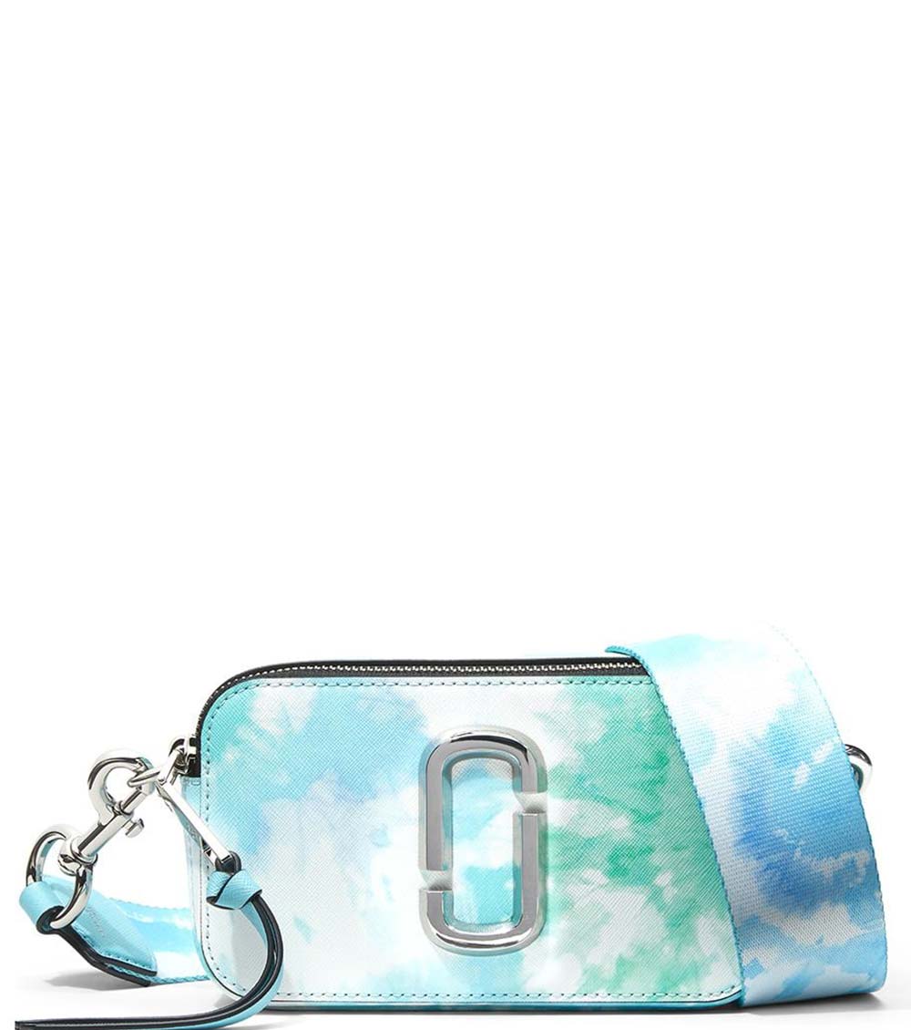 Marc Jacobs Blue Snapshot Dye Small Crossbody Bag for women, featuring a unique tie-dye pattern in shades of blue. The bag includes an adjustable strap and a compact design, making it a stylish and eye-catching accessory for everyday use."



