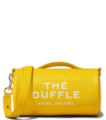 "Marc Jacobs Yellow The Duffle Crossbody Bag for women, featuring a bright yellow color and a compact duffle design. The bag includes an adjustable strap and a spacious interior, making it a stylish and practical accessory for everyday use."



