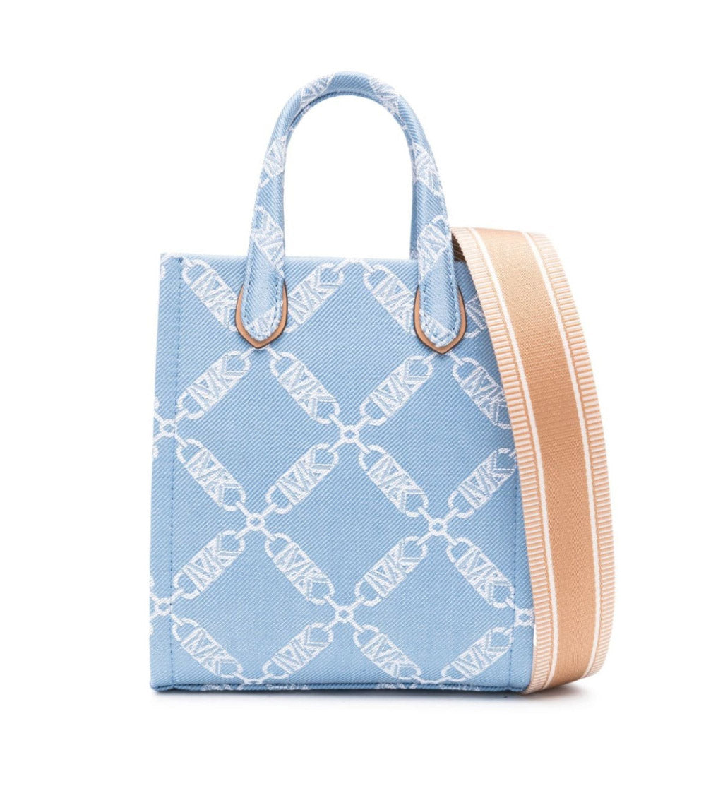  "Michael Kors Blue Gigi Shopping Bag for women, featuring a chic blue design with a spacious interior and elegant handles. Crafted from high-quality materials, this bag combines style and functionality, making it perfect for everyday use."



