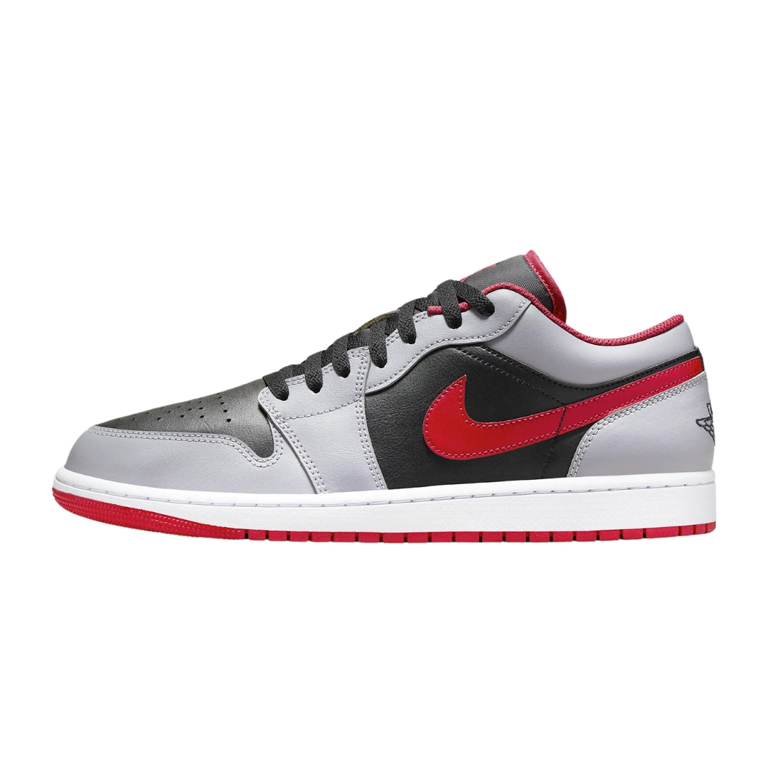  Nike Air Jordan 1 Low "Black Cement Grey Fire Red" sneakers featuring a mix of black leather and grey accents, complemented by vibrant red details. The low-top design includes a black swoosh and a white midsole, set against a neutral background to highlight the shoe's bold colorway.