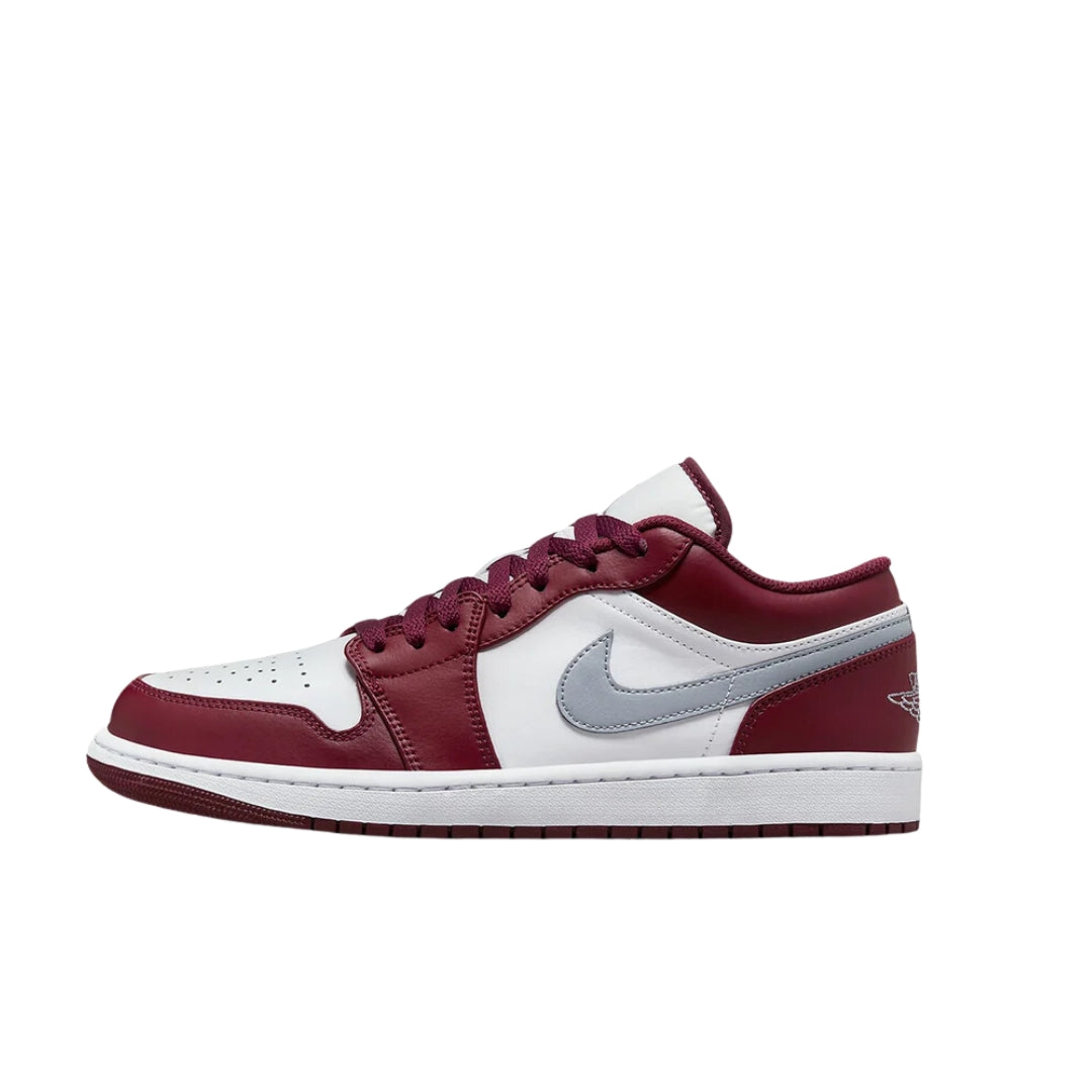 Nike Air Jordan 1 Low sneakers in the 'Bordeaux' colorway, showcasing a low-top silhouette with a deep burgundy upper, white leather overlays, and a rubber outsole, blending style and comfort."