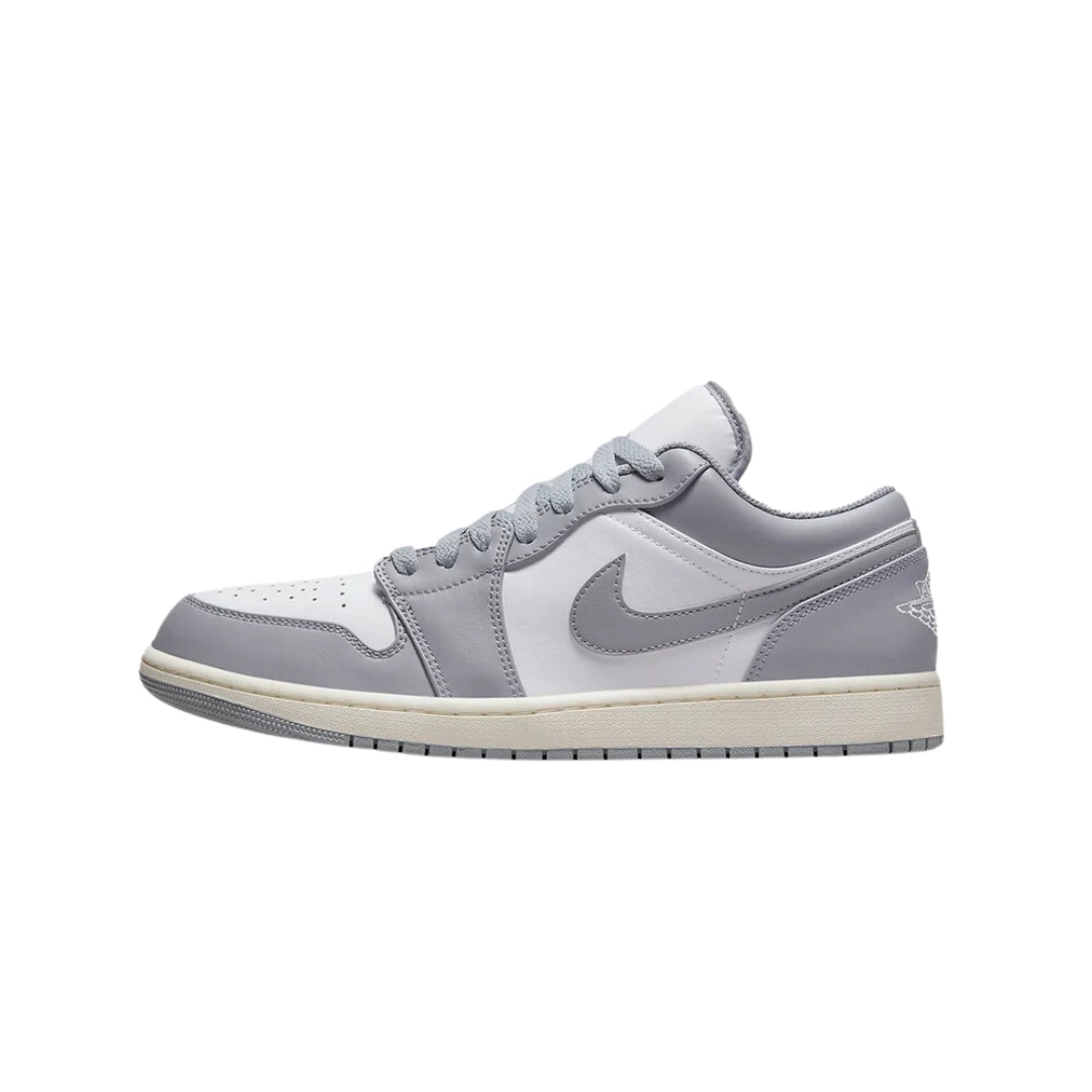 Nike Air Jordan 1 Low "Vintage Stealth Grey" sneakers featuring a soft grey leather upper with vintage-inspired accents. The low-top design includes a white midsole and subtle black details, displayed against a neutral background to emphasize the shoe's classic style.



