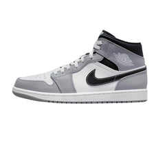 Nike Air Jordan 1 Mid "Light Smoke Grey Anthracite" sneakers featuring a combination of light grey leather and anthracite accents. The mid-top design includes a classic silhouette with a white midsole and a black swoosh, displayed against a neutral background to highlight the shoe's stylish colorway and contemporary look.



