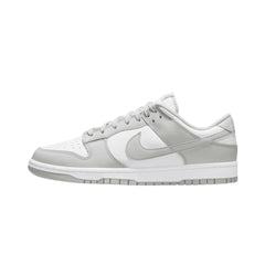 Nike Dunk Low sneakers in the 'Grey Fog' colorway, featuring a soft grey upper with contrasting white leather overlays, a low-top silhouette, and a classic rubber outsole for a clean and stylish appearance."



