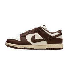  Nike Dunk Low "Mocha Cacao" sneakers featuring a rich brown leather upper with contrasting white accents. The classic low-top design includes a white midsole and a mocha-colored swoosh, showcased against a neutral background to highlight the shoe's stylish colorway and contemporary appeal.



