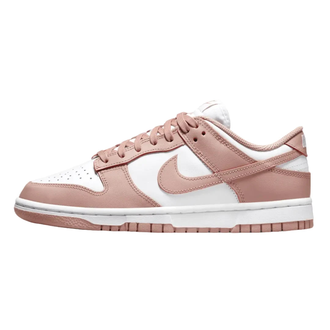  Nike Dunk Low "Whisper Rose" sneakers featuring a soft, blush pink leather upper with white accents. The classic low-top design includes a white midsole and matching laces, showcased against a neutral background to emphasize the shoe's feminine color palette and stylish appeal.