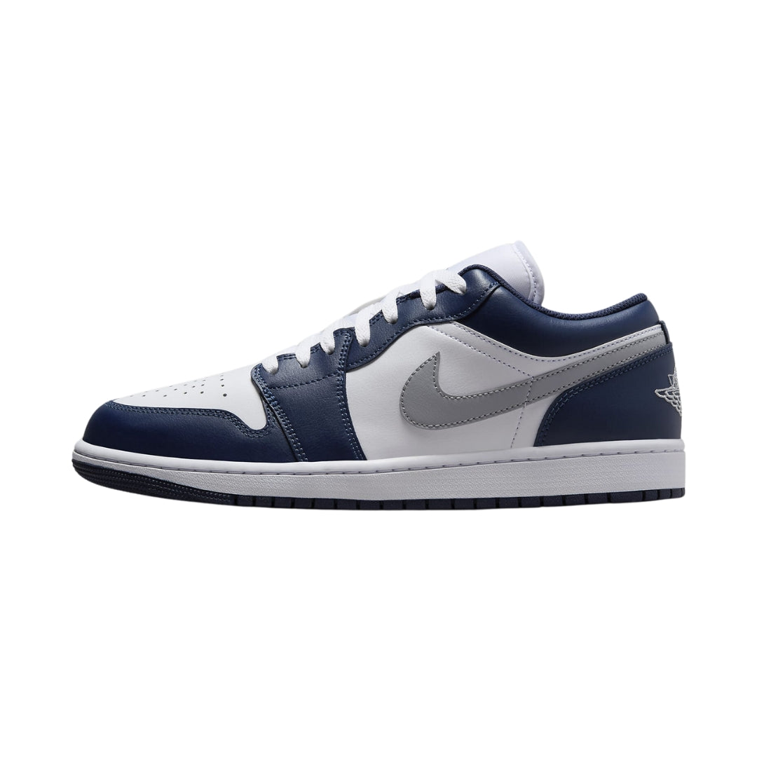 "Nike Air Jordan 1 Low in Wolf Grey and Midnight Navy, showcasing a smooth grey leather upper with navy accents on the Swoosh and heel. The design features a classic low-top silhouette and the iconic Jordan logo."