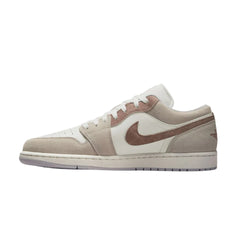 "Nike Air Jordan 1 Low SE in Legend Light Brown, featuring a soft leather upper in a warm light brown hue with contrasting white and dark brown accents. The shoe showcases the iconic Air Jordan logo on the side, a low-profile design, and a classic rubber sole."