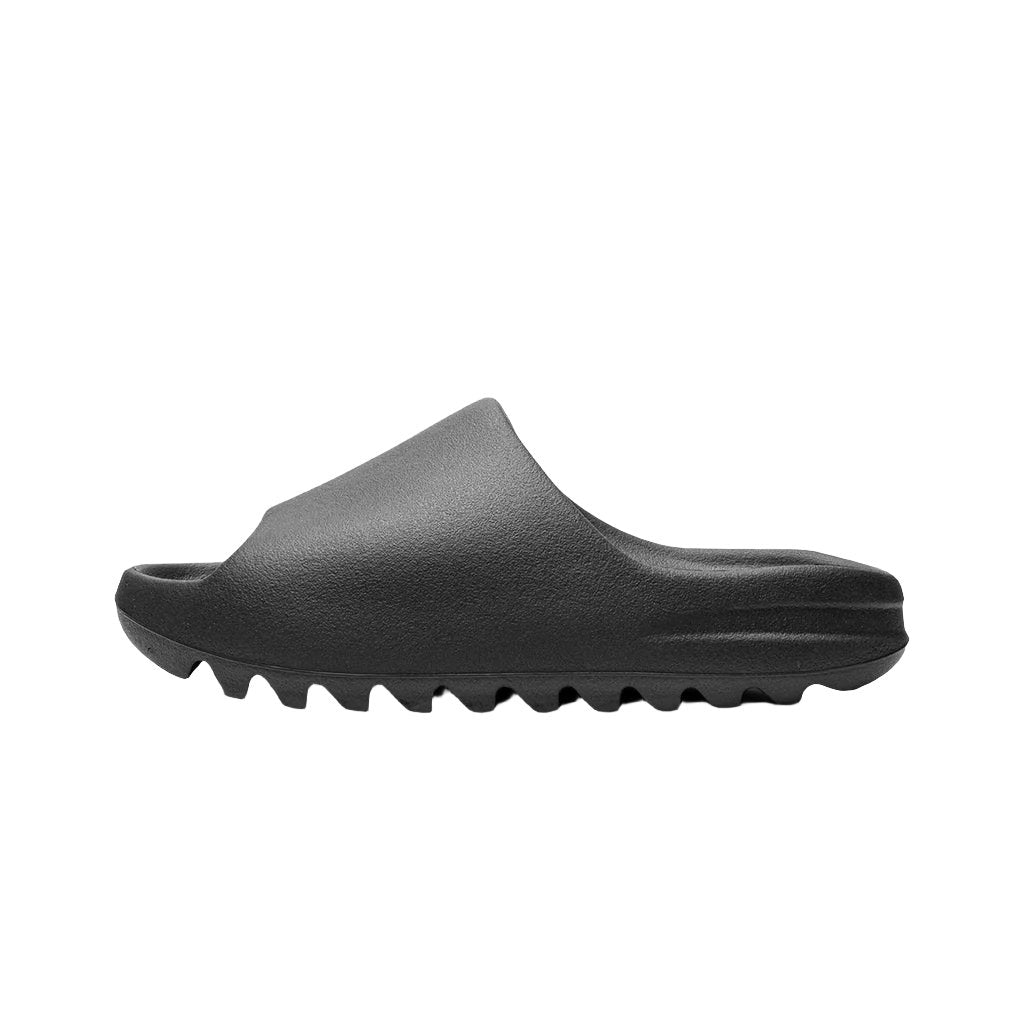 Adidas Yeezy Slide 'Onyx' sandals, featuring a sleek, minimalist design in a solid black color. The slides have a smooth finish and a contoured footbed for comfort, with a wide strap that offers a secure fit, perfect for casual wear."



