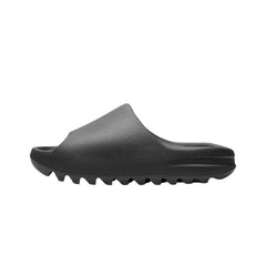 Adidas Yeezy Slide 'Onyx' sandals, featuring a sleek, minimalist design in a solid black color. The slides have a smooth finish and a contoured footbed for comfort, with a wide strap that offers a secure fit, perfect for casual wear."



